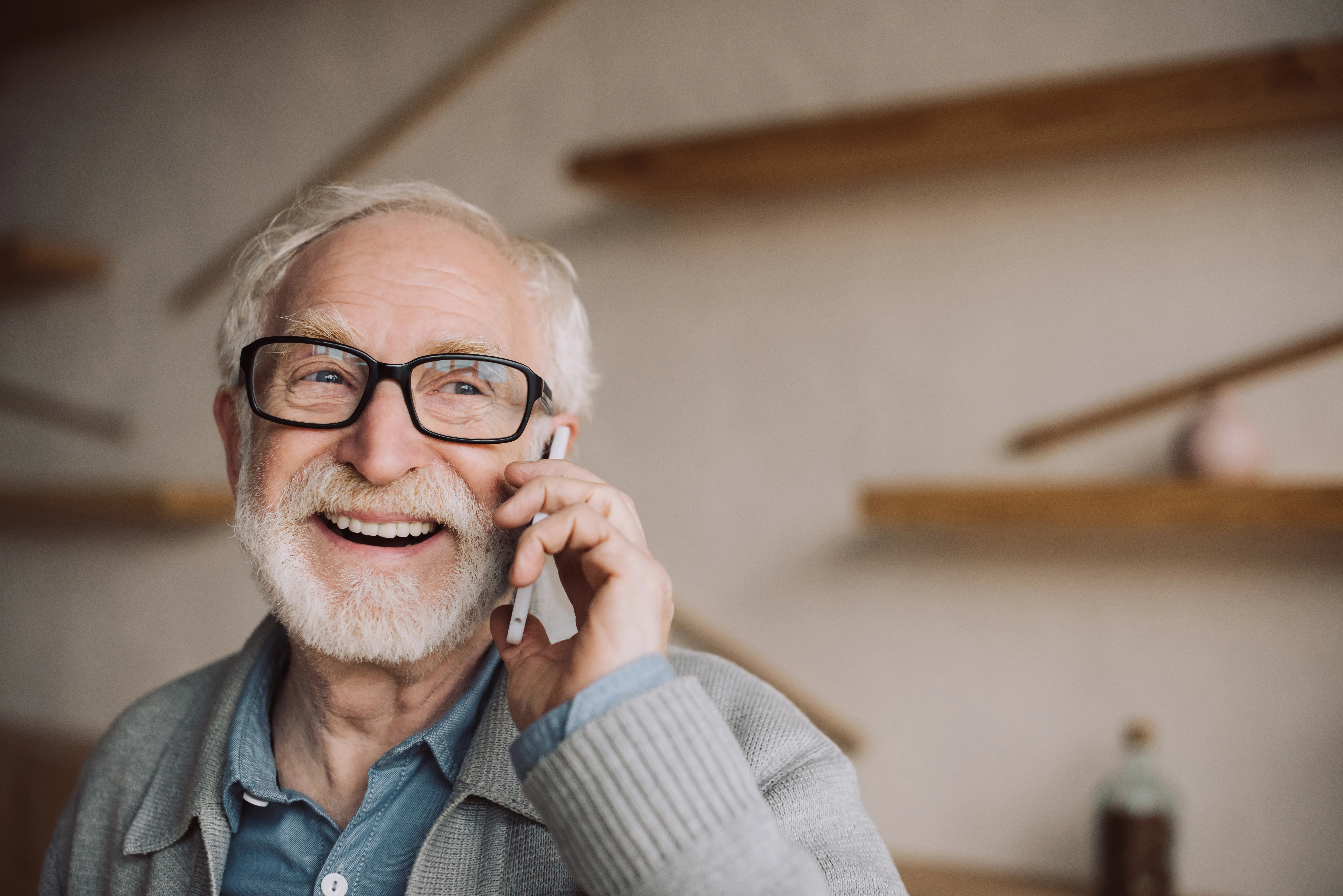 happy bearded senior man talking by phone
