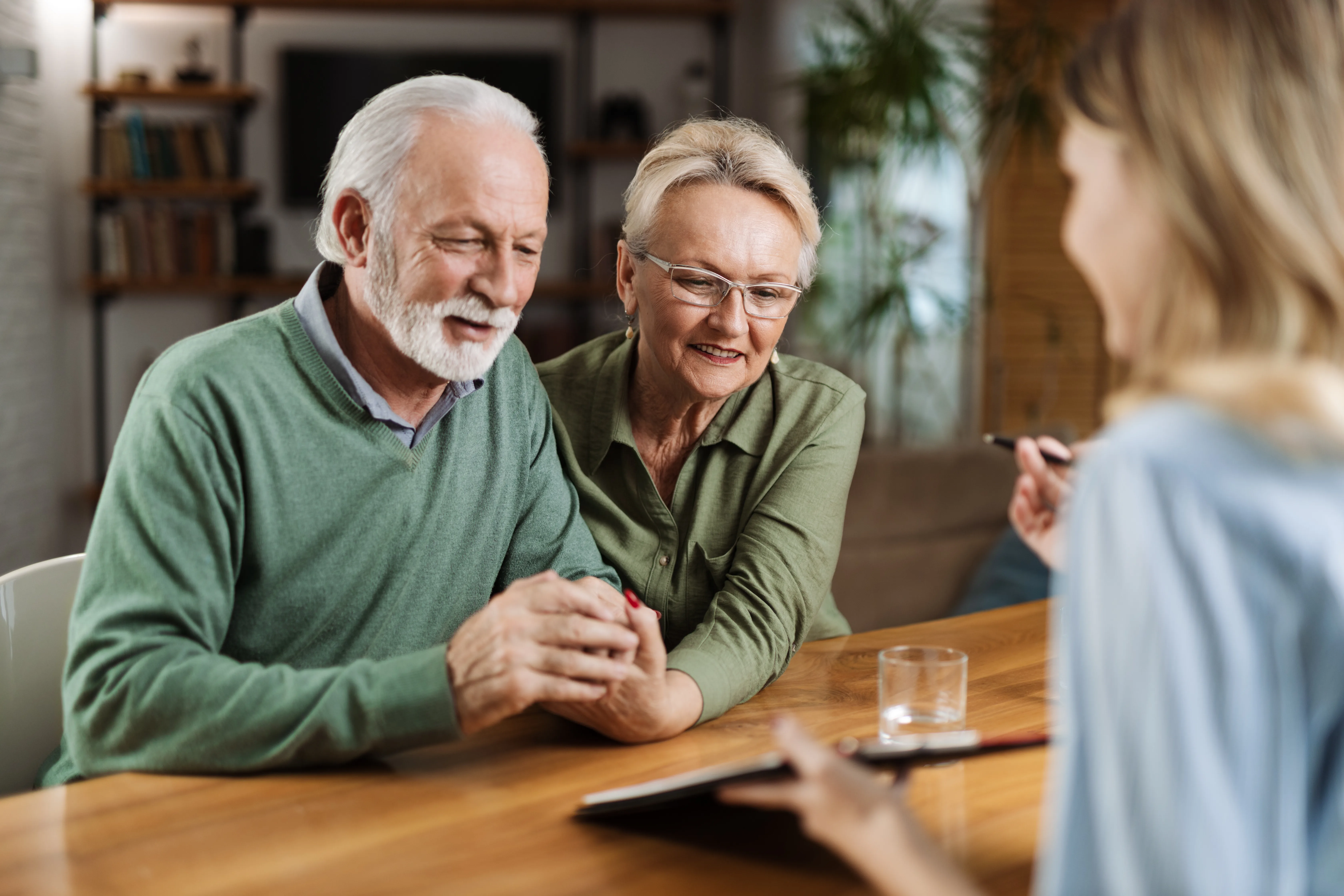 Mature couple having a meeting with their financial advisor Happy senior couple having a meeting with their insurance agent at home