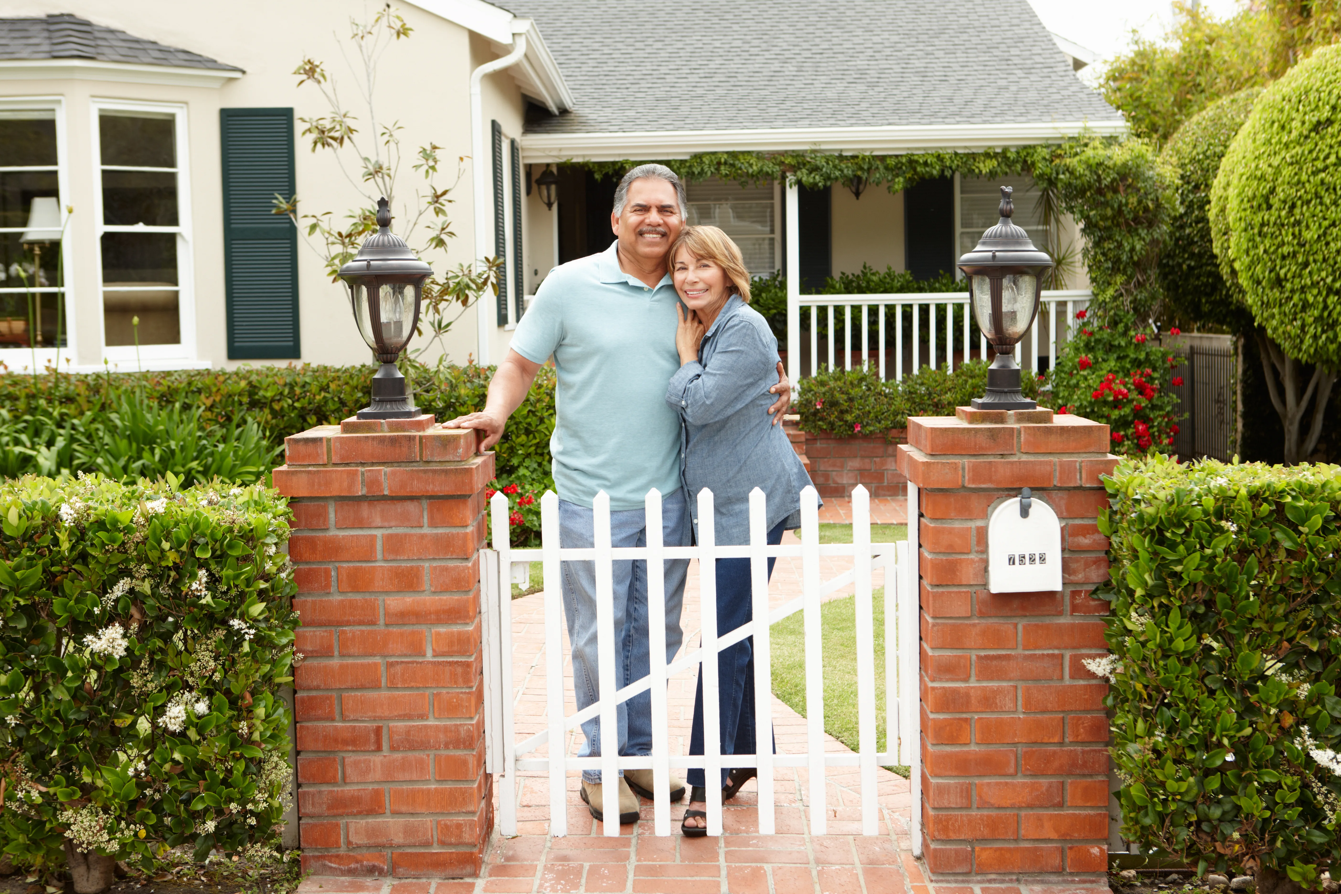 Senior Hispanic couple outside home